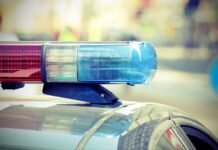 Close-up of a police cars light bar with blue and red lights