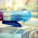 Close-up of a police cars light bar with blue and red lights