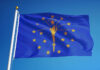 Indiana state flag waving against a blue sky