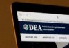 Laptop screen showing DEA website header