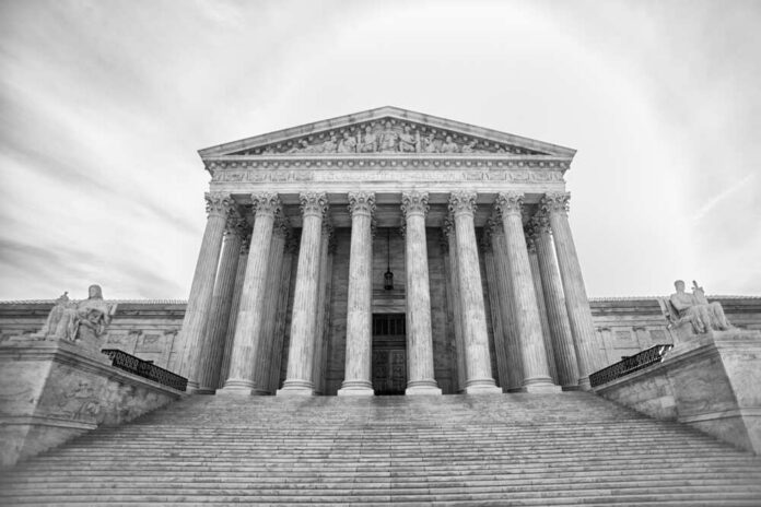 Front view of the Supreme Court building with columns and statues