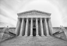 Front view of the Supreme Court building with columns and statues