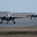 Two F-35 fighter jets taxiing on an airfield