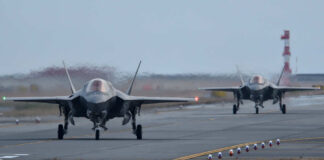 Two F-35 fighter jets taxiing on an airfield