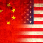 China’s Grip Threatens U.S. Weapons Flags of China and the USA blended together with a textured background