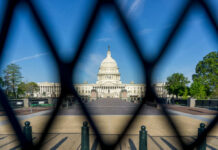 Congress Quietly Locks In $70B Crackdown View of the U.S. Capitol building through a security fence