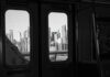 NYC Subway Horror: Chilling Antisemitic Attack View of a city skyline through subway windows in black and white