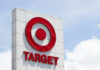 Target store sign featuring a red logo against a blue sky