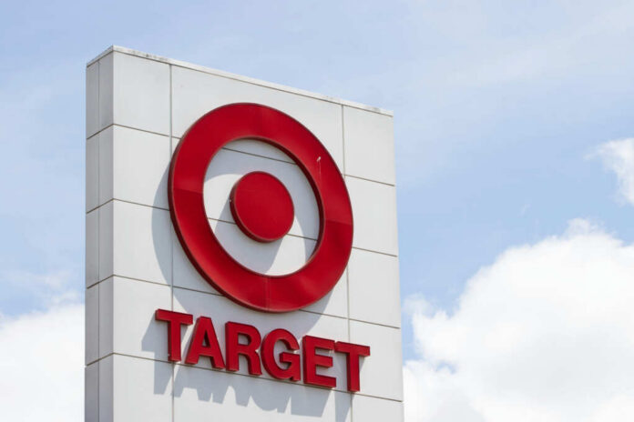 Target store sign featuring a red logo against a blue sky