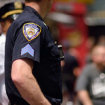 Close-up of a police officers uniform in a busy urban area