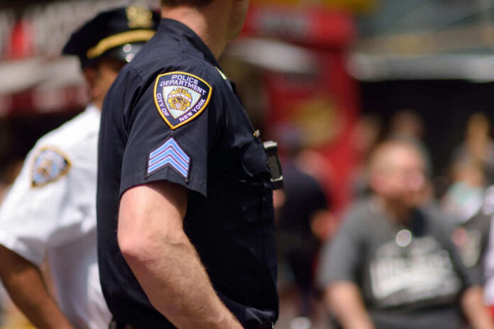 Close-up of a police officers uniform in a busy urban area