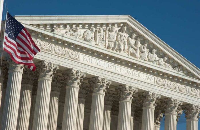 United States Supreme Court facade with flag and Corinthian columns