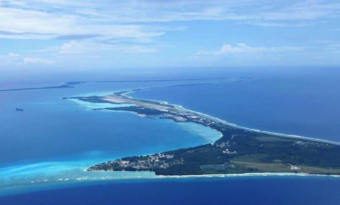 Aerial view of a tropical island surrounded by blue ocean waters
