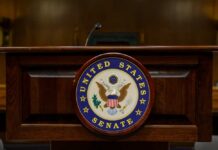 Podium with the United States Senate seal in a formal setting