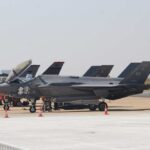 Most Expensive Jet Ever? China Pounces F-35 military jets parked on an airfield with crew members nearby