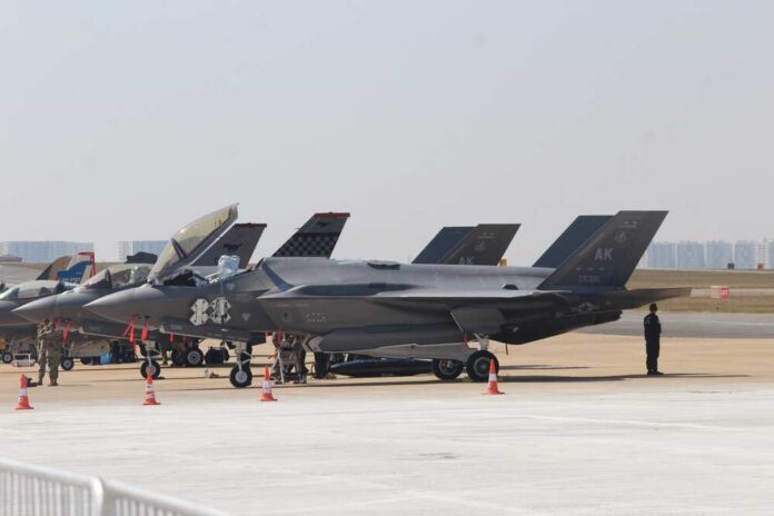 On,14th,February,2023,,The,Lockheed,Martin,F-35,Fighter,Jet F-35 military jets parked on an airfield with crew members nearby