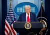Trading Tsunami Shadows The White House A political figure at a podium during a press conference in front of the White House