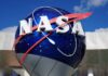 Taxpayers Fume Over NASA Goalposts NASA logo displayed on a large blue globe against a clear sky