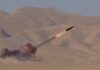 Houthis Claim Strikes—Proof Comes Up Thin A missile launching into the sky with smoke and flames in a desert setting