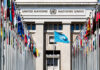 Governments Blamed In Record Child War Crimes United Nations building with multiple international flags in front