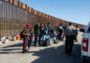 Spain Surge Sparks Chilling U.S. Warning Border patrol agents interact with a group of people.