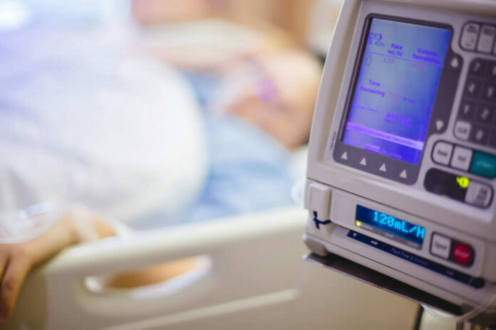 shutterstock1449440597jpg IV pump displaying medication flow rate in a hospital room