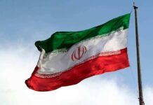 Tehran Dangles Millions For Assassinations Iranian flag waving on a pole