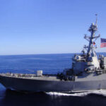 Mystery Overboard: Navy Halts Arabian Sea Hunt A naval destroyer sailing in the ocean with an American flag