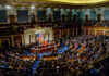Stunning House Split Jolts Israel Funding A large gathering of officials in a congressional chamber during a legislative session