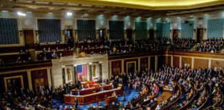 A large gathering of officials in a congressional chamber during a legislative session