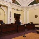 Another Epstein Insider Dead — Questions Explode empty courtroom with judge's bench and columns