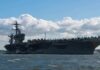 Navy’s One‑Cent Deal Sparks Taxpayer Fury Aircraft carrier at sea with fighter jets on deck