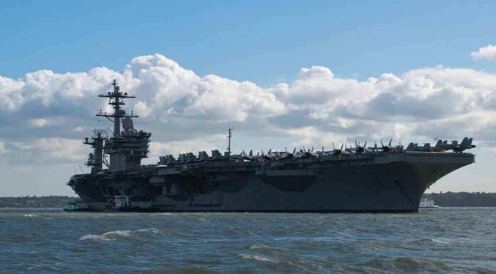 shutterstock_1347055766 Aircraft carrier at sea with fighter jets on deck