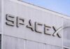 Million-Satellite Gambit Rattles Wall Street SpaceX logo on a building facade