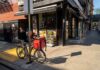 Delivery bicycle parked outside a corner deli