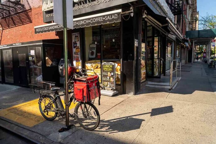 shutterstock_1723062862 Delivery bicycle parked outside a corner deli