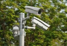 Back-Door Surveillance — Congress Strikes Back surveillance cameras mounted on a metal pole