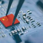 Market Panic Over ‘Homemade’ Chip Machines Microchip with China flag held by tweezers on circuit board