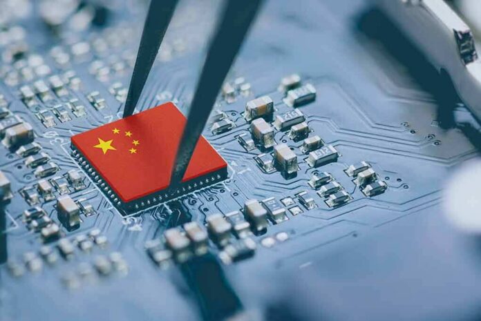 shutterstock_2171952485 Microchip with China flag held by tweezers on circuit board
