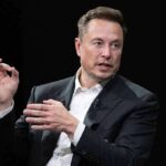 Doomsday Escape? Musk Dangles Mars Lifeline man in a suit speaking with hand gestures