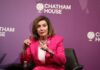 A woman in a pink suit speaking at a Chatham House event