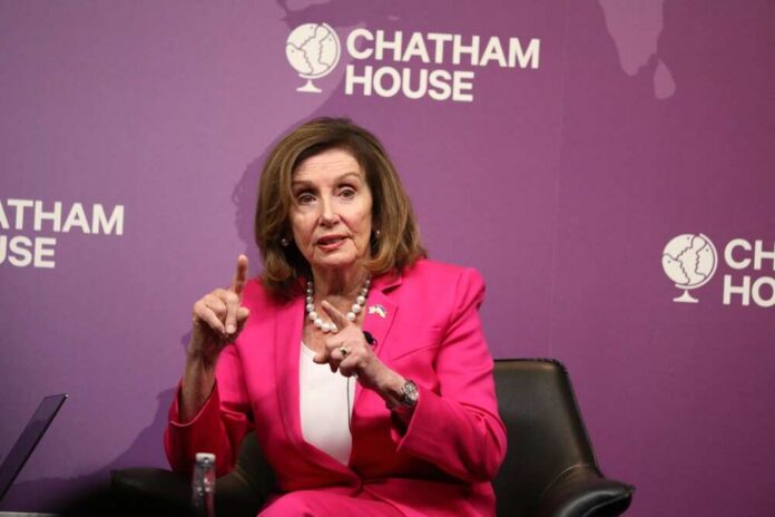 A woman in a pink suit speaking at a Chatham House event