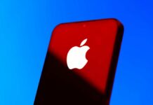 Market Kingpin Flips: Apple vs. Nvidia Close-up of a smartphone with the Apple logo against a red and blue background