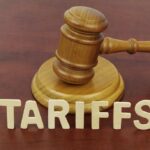 Tariff Whiplash Sends Toyota to Texas A wooden gavel next to the word 'TARIFFS' spelled out in wooden letters