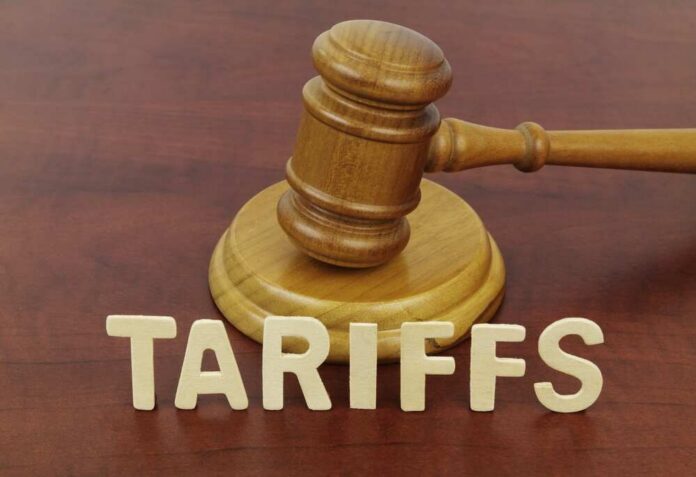Word,Tariffs,And,Judge,Gavel,Close-up. A wooden gavel next to the word 'TARIFFS' spelled out in wooden letters