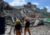 Rescue workers search a collapsed building site