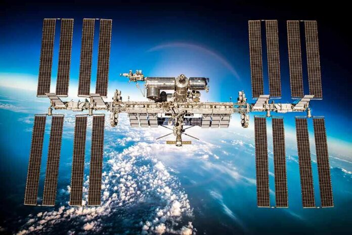 shutterstock_311480090 International Space Station with large solar arrays over Earth