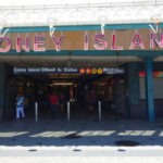 Holiday Cookout Erupts—Children Caught In Crossfire Entrance to Coney Island subway station with people walking