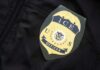 ICE officer badge on a dark uniform