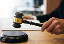 Court Freeze Hits Assisted-Death Rollout Judge's hand holding a gavel over a sound block